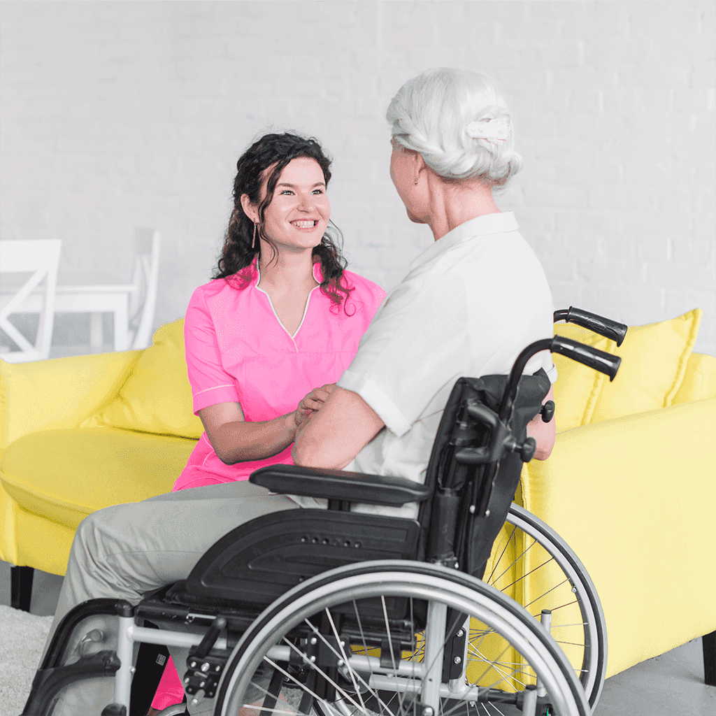 nurse smiling at senior in wheelchair