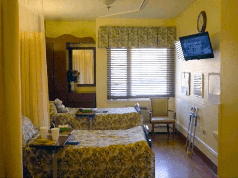 room with two beds and tv