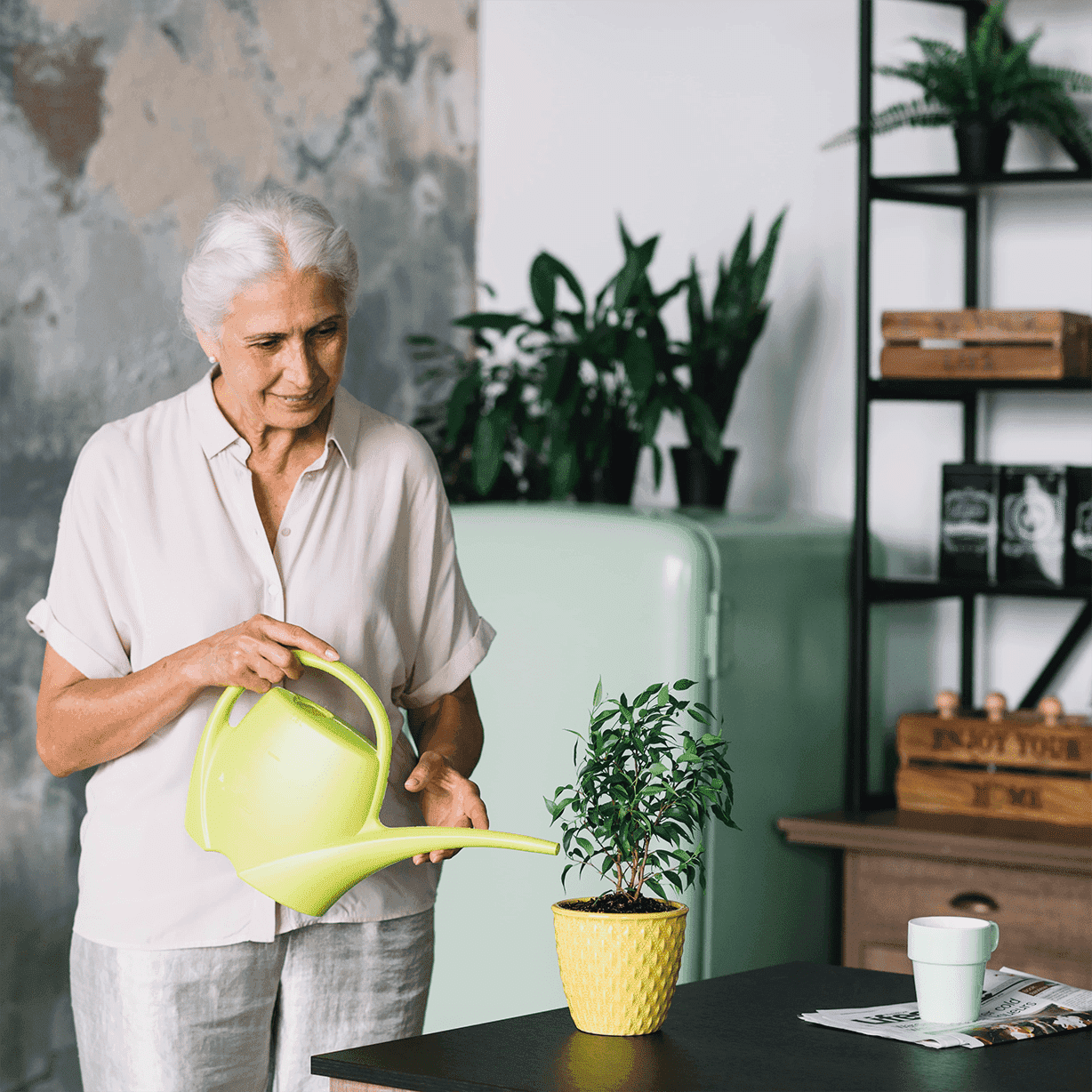 Older woman watering potted plant