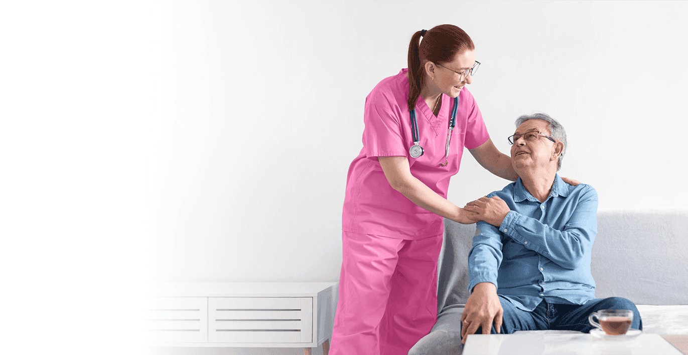 Young readhead caregiver touching older man on the shoulders