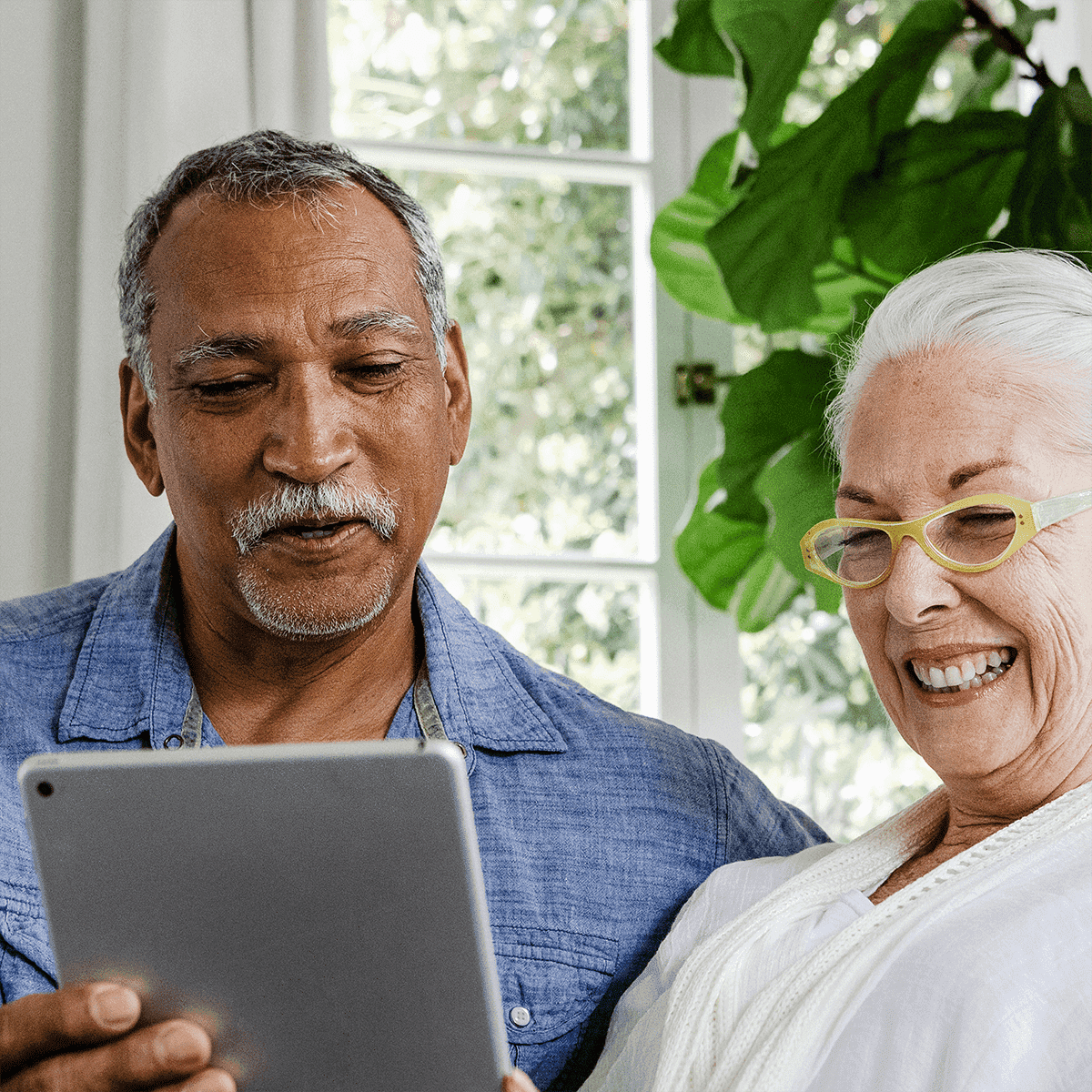 Elderly couple using tablet