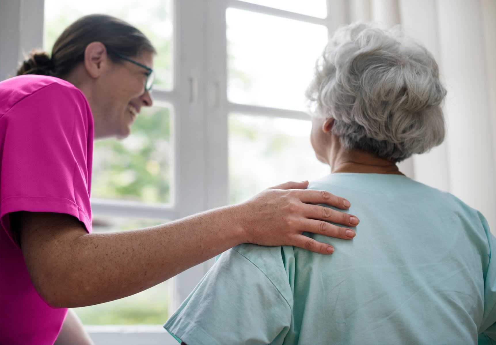 caregiver touching shoulder of senior