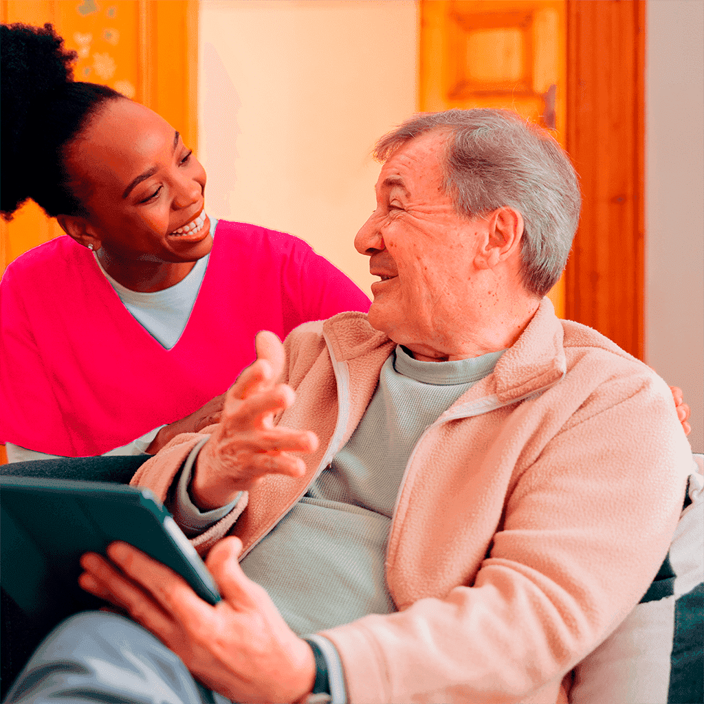 nurse and older man smiling while having a chat