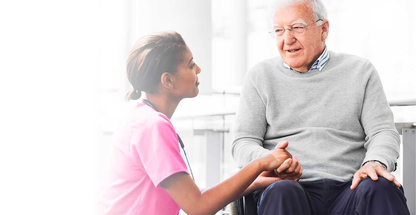 caregiver holding hand of elder