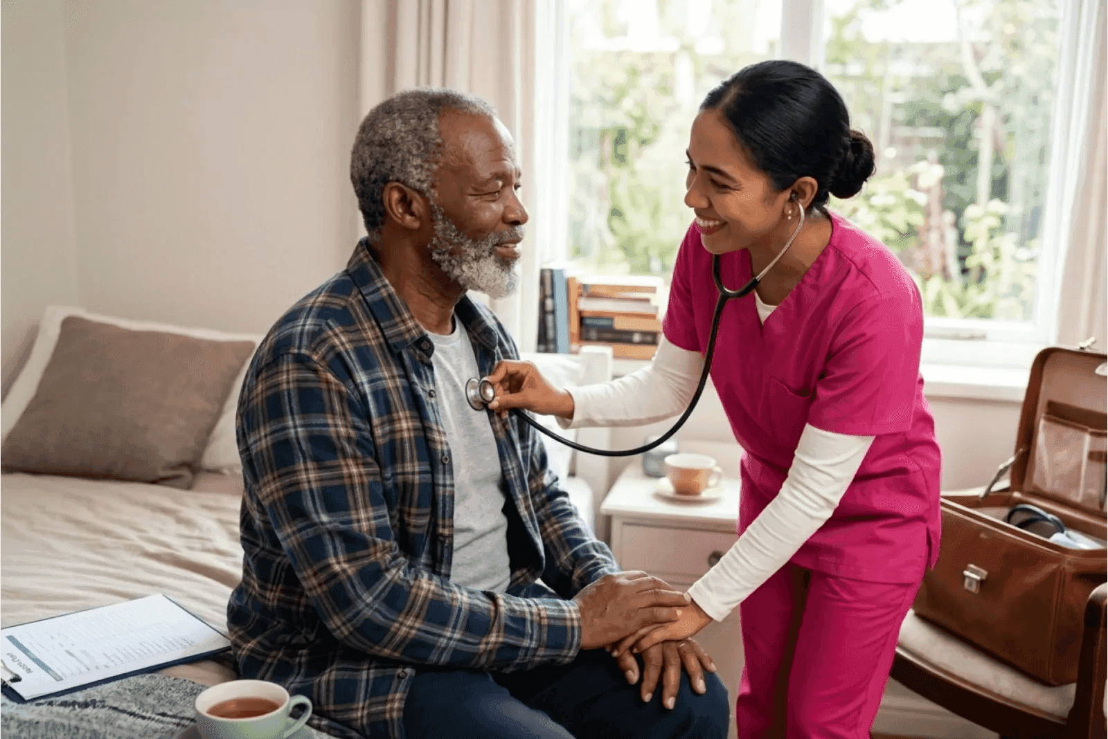 caregiver and senior client having a conversation at home