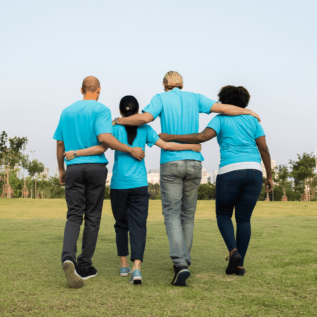 4 nurses holding each others backs