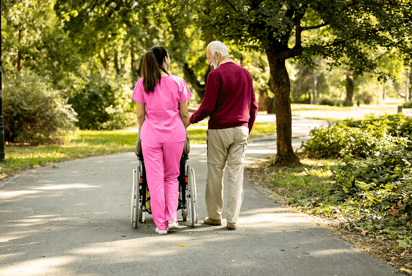 caregiver walking with a couple of senior