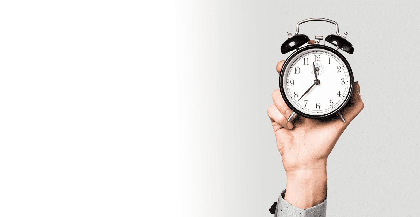 Man's hand holding vintage clock