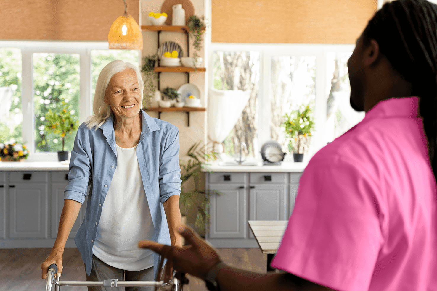 elder lady with walker smiling at caregiver