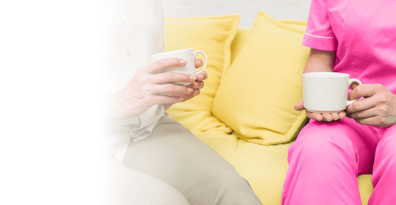 caregiver and senior having tea