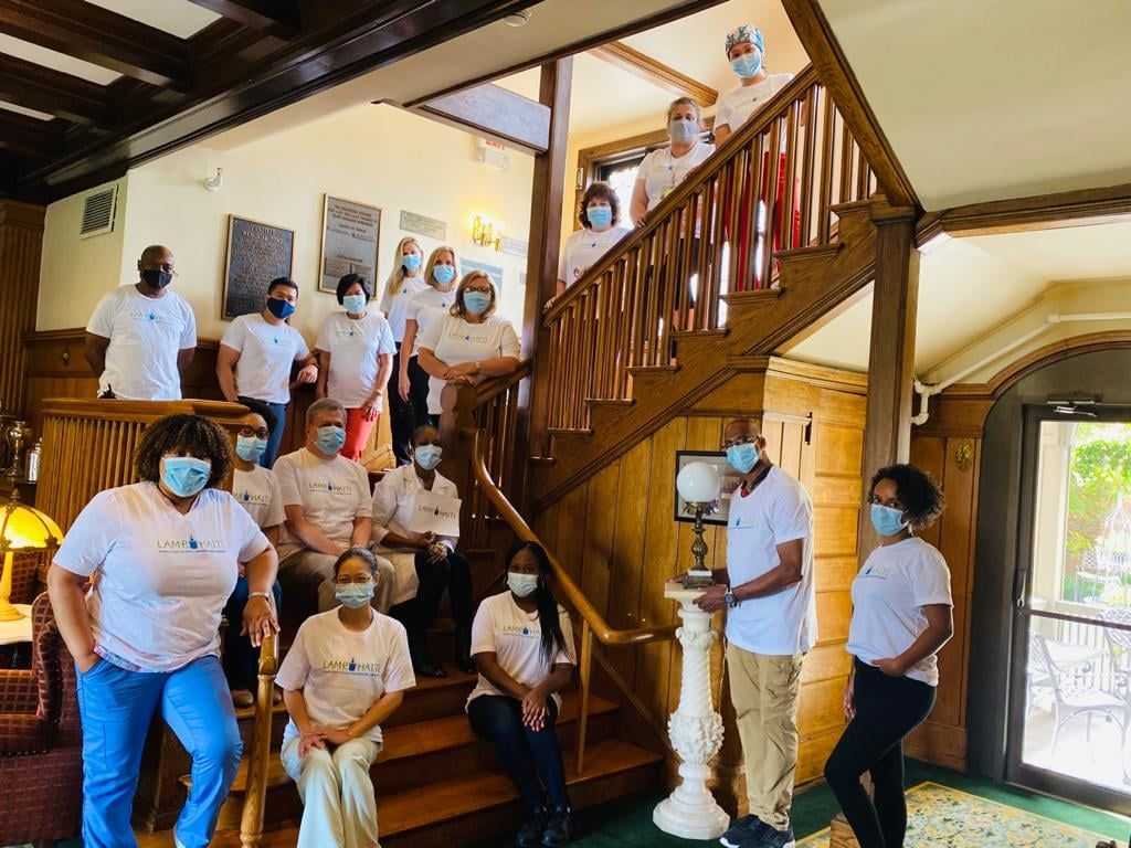 Job Haines staff gathered on stairs posing for picture